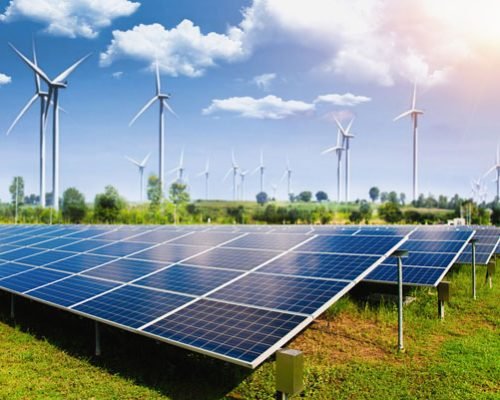 solar-panel-with-wind-turbines-against-mountains-sky